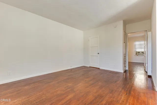 a view of an empty room and wooden floor