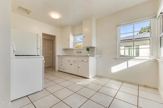 a kitchen with stainless steel appliances a refrigerator sink and cabinets