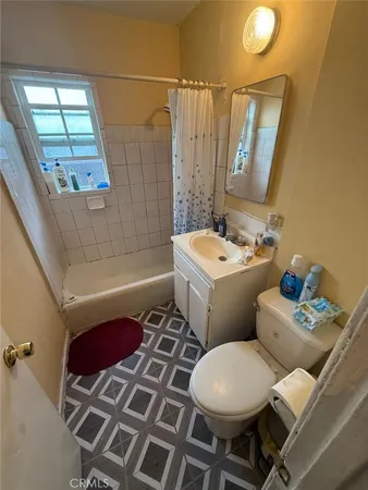 a kitchen with sink a refrigerator and a stove