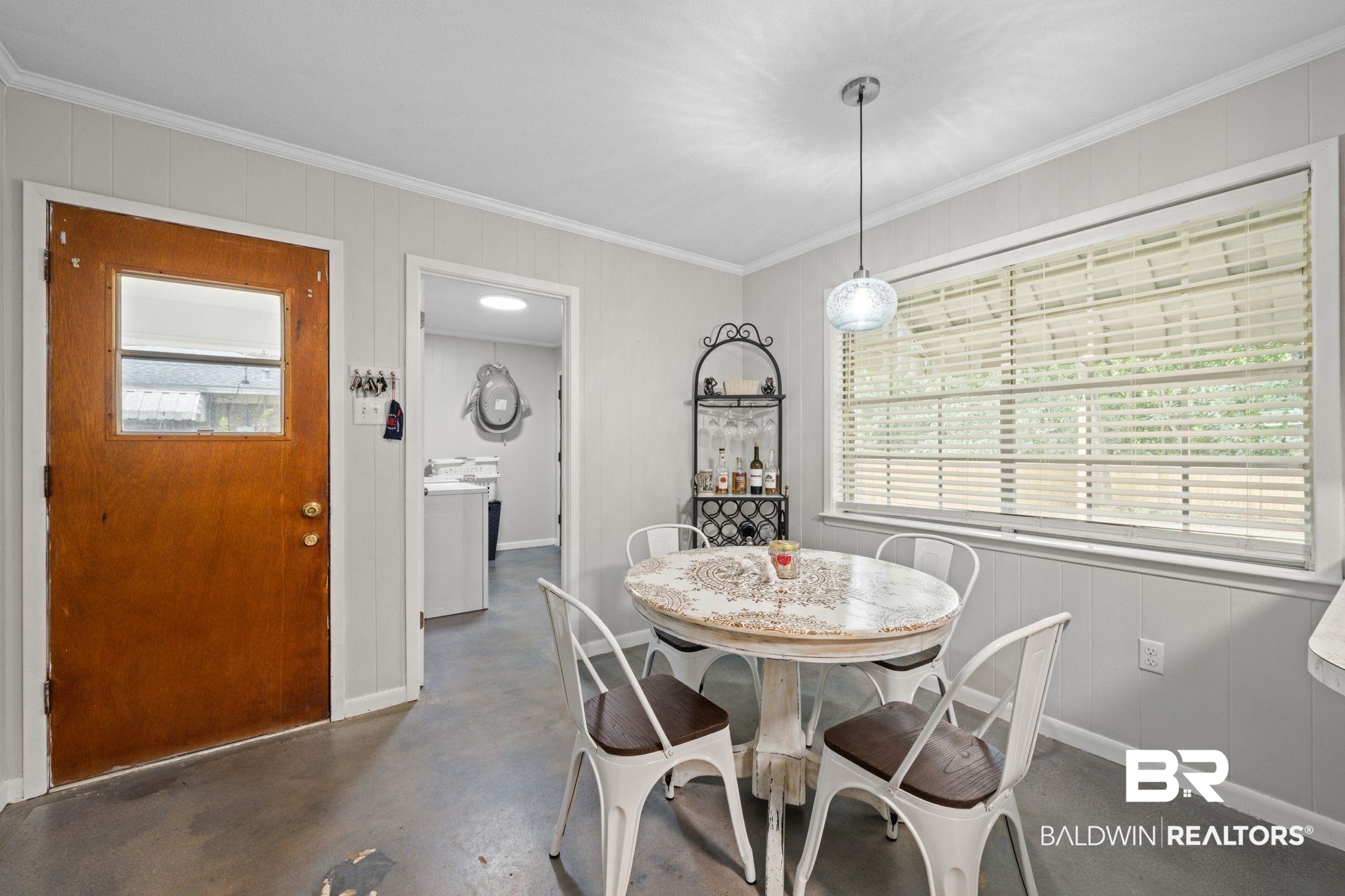 621 Ann Street Saraland, AL 36571 - Photo 7 of 21 Dining space featuring washer / clothes dryer and crown molding
