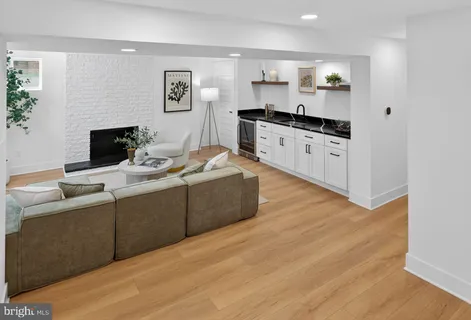 a living room with furniture and kitchen view