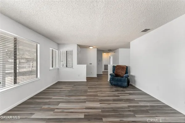 a view of a bedroom with wooden floor