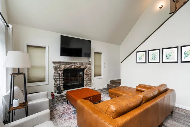 a living room with furniture and kitchen view
