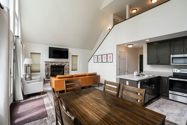 a view of kitchen with stainless steel appliances kitchen island granite countertop a refrigerator and a sink
