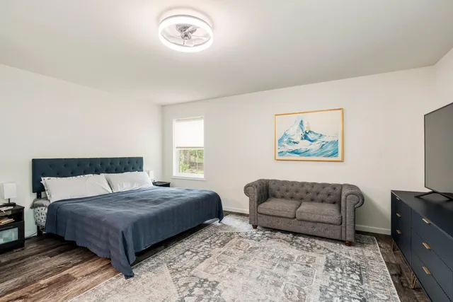 a living room with furniture and a walk in closet