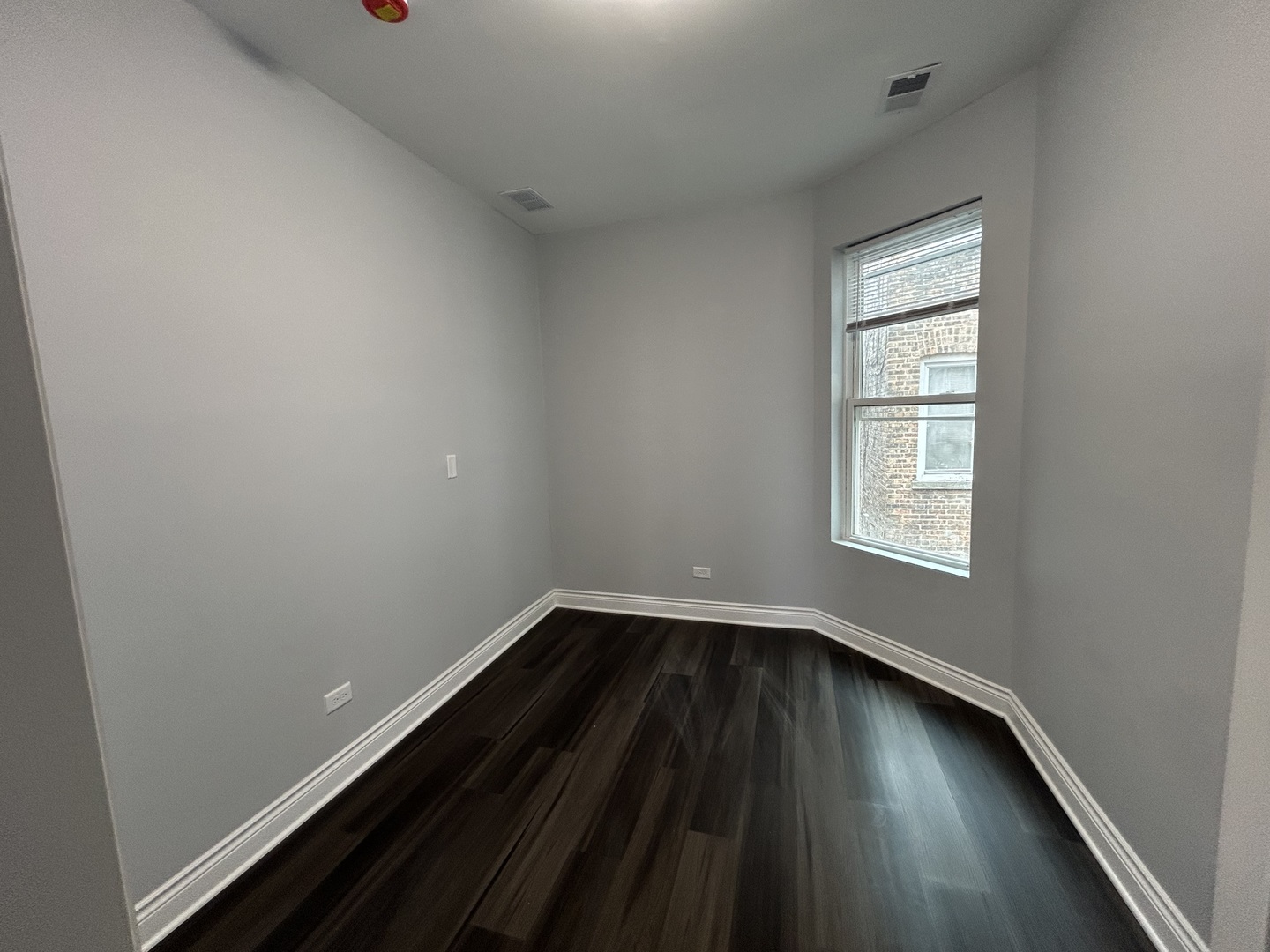 7940 South Carpenter Street, Unit 2 Chicago, IL 60620 - Photo 32 of 34 an empty room with wooden floor and windows