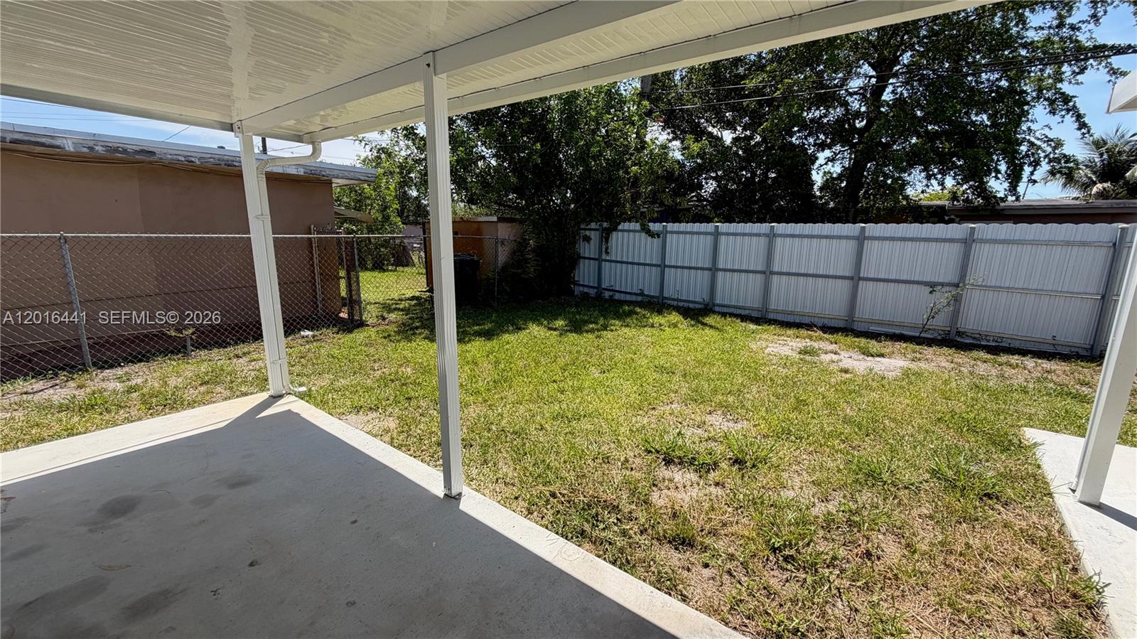 2230 Service Road Opa-Locka, FL 33054 - Photo 20 of 25 a view of a backyard with floor to ceiling window and wooden fence