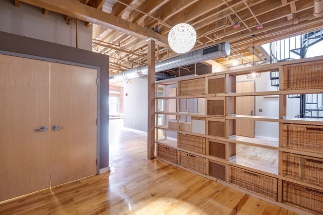 a view of a room with wooden floor and windows