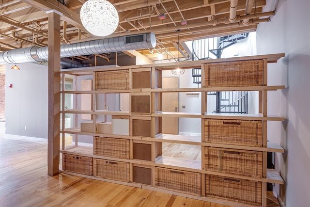 a view of a room with wooden floor and windows