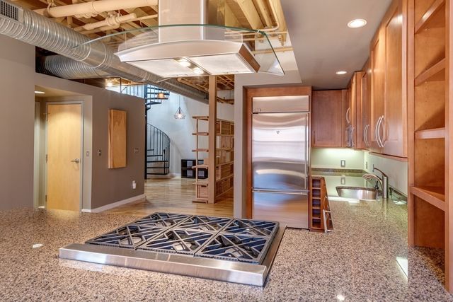 a kitchen with stainless steel appliances granite countertop a stove and a refrigerator