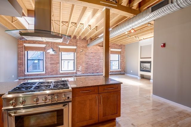 a kitchen with stainless steel appliances granite countertop a stove and a sink