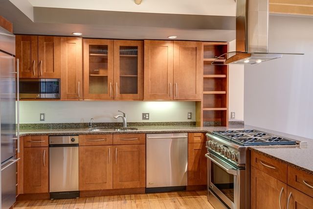 a kitchen with granite countertop a stove and a sink