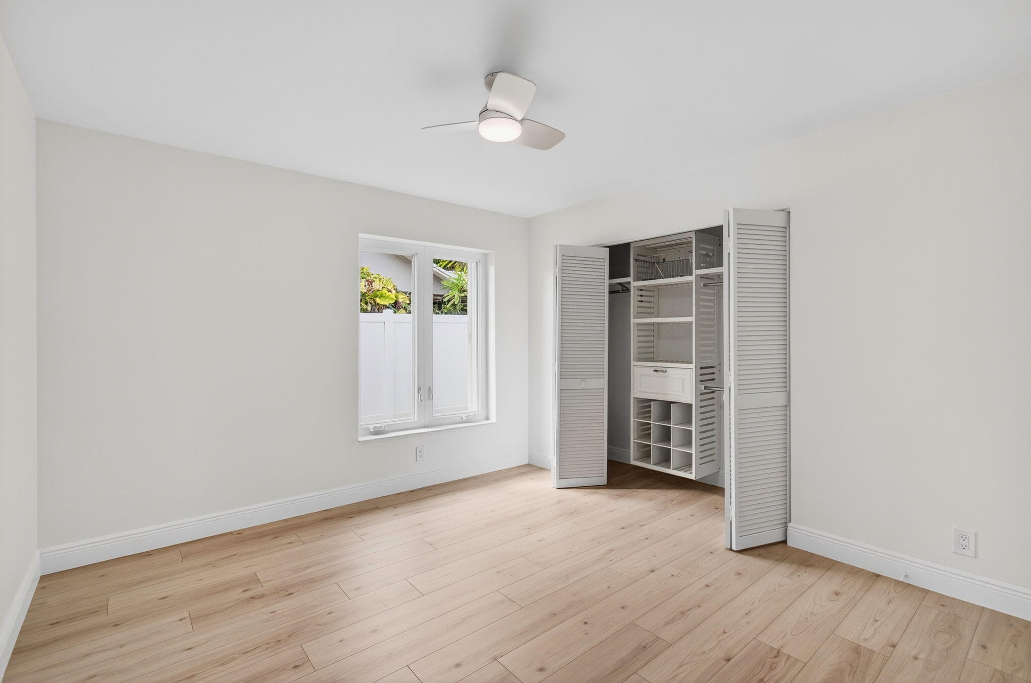 17350 Springtree Lane Boca Raton, FL 33487 - Photo 47 of 83 an empty room with window and wooden floor