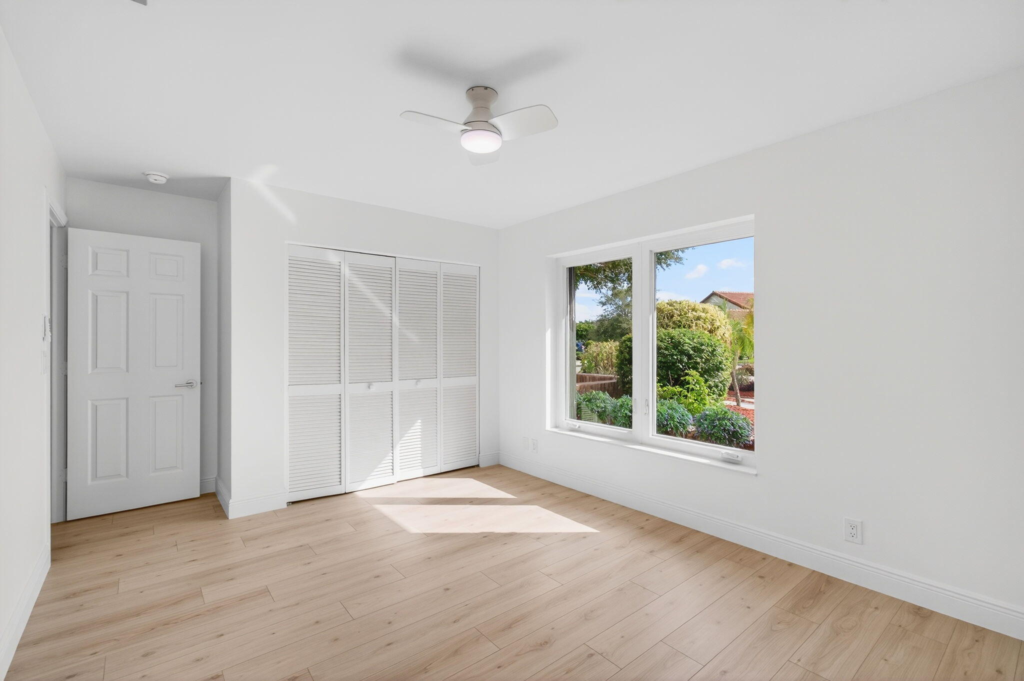 17350 Springtree Lane Boca Raton, FL 33487 - Photo 53 of 83 an empty room with wooden floor and windows