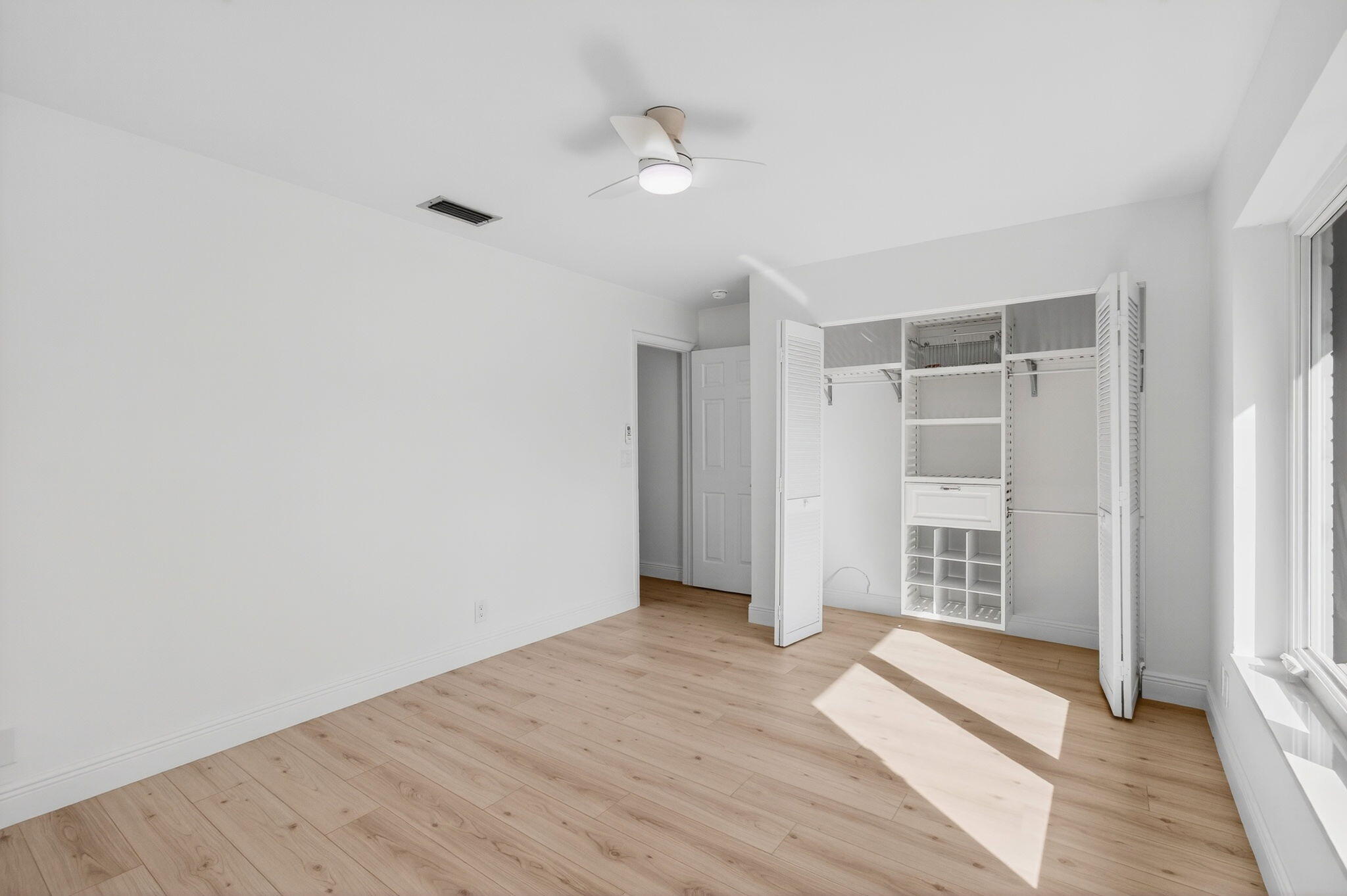 17350 Springtree Lane Boca Raton, FL 33487 - Photo 54 of 83 an empty room with wooden floor and windows
