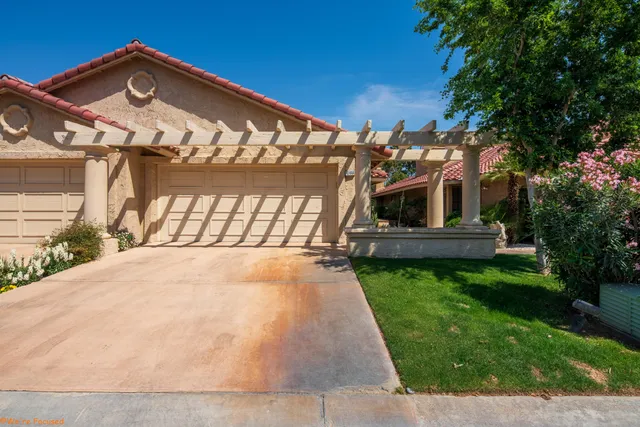 a view of a house with a large window and a yard