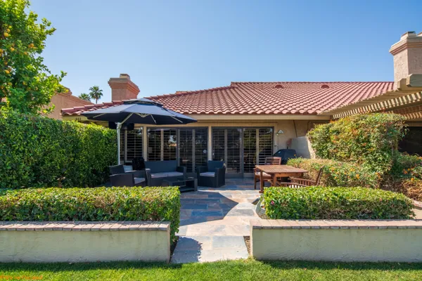 a front view of a house with a yard table and chairs