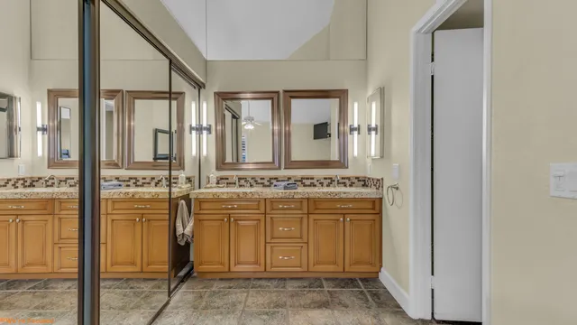 a bathroom with a granite countertop sink and a mirror