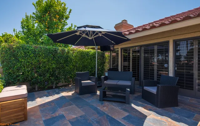 a patio with hardwood table and chairs