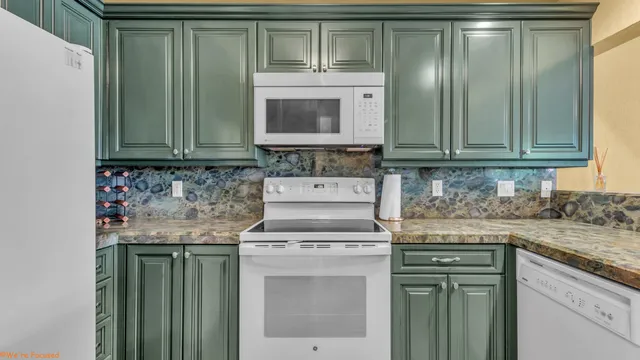 a kitchen with granite countertop a sink and a stove