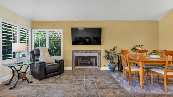 a living room with furniture a flat screen tv and a fireplace