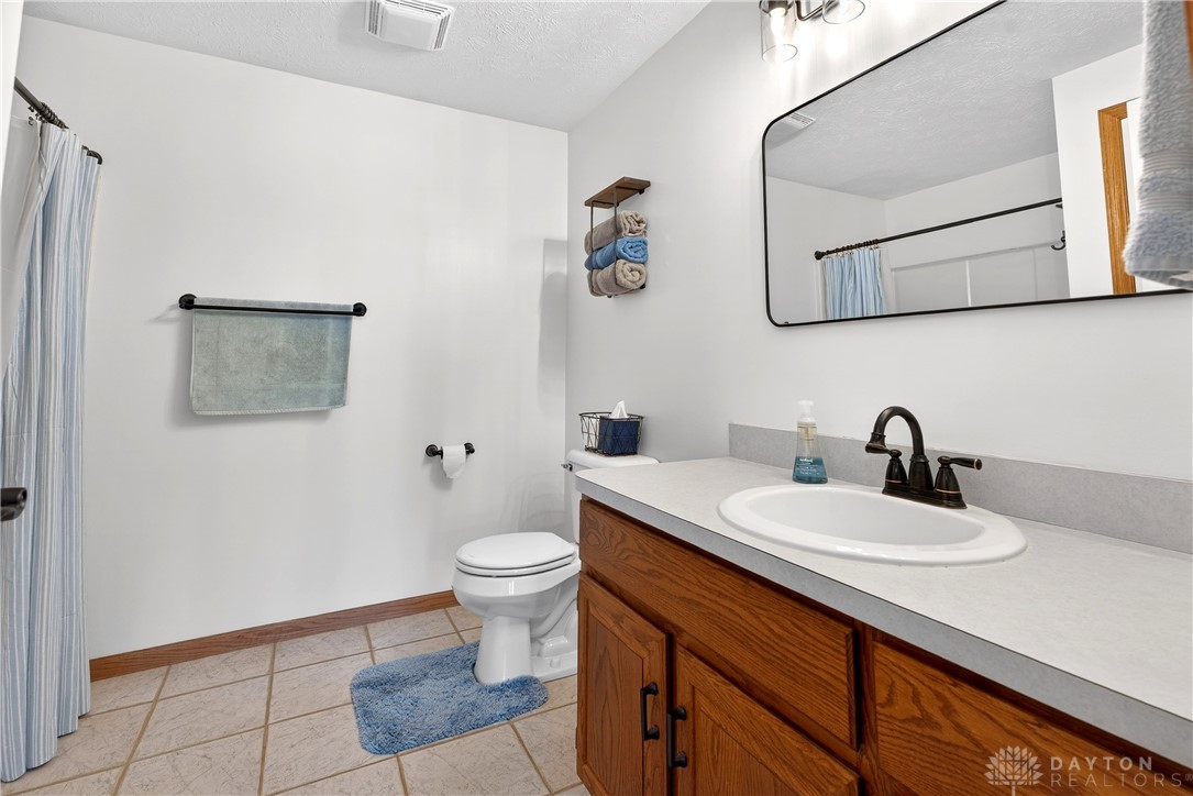 6560 Snyder Road Fletcher, OH 45326 - Photo 41 of 71 This bathroom features a simple vanity, modern mirror, and light-colored tile flooring.