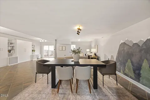 a dining room with a table and chairs