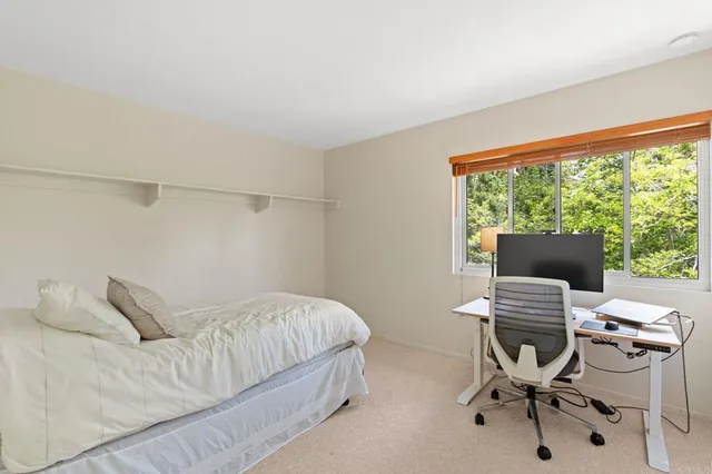 a bedroom with a bed and a desk