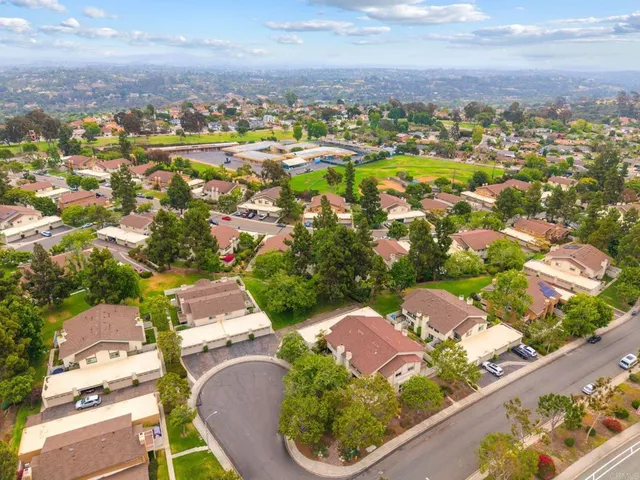 an aerial view of residential houses with outdoor space