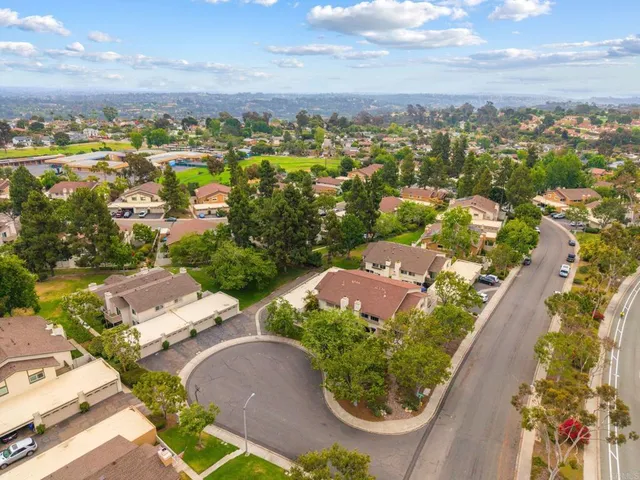 an aerial view of residential houses with outdoor space