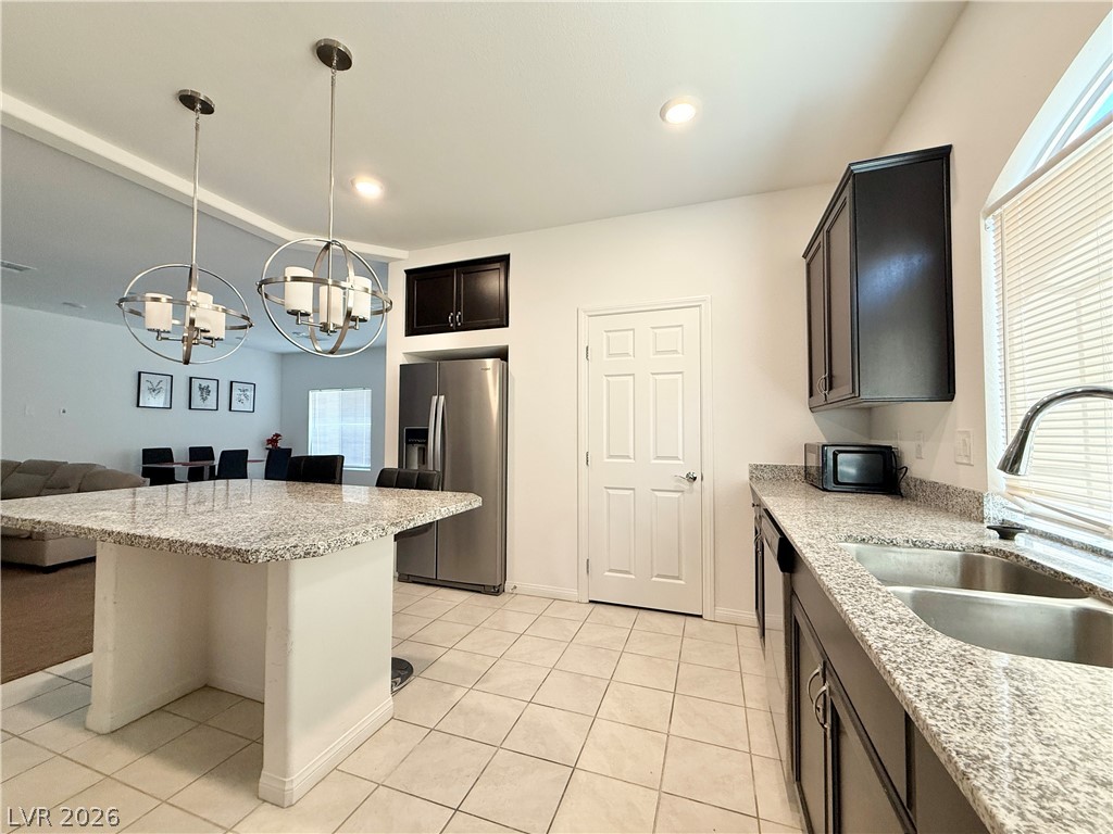 7777 South Westwind Road Las Vegas, NV 89139 - Photo 31 of 46 Modern kitchen features granite countertops and stainless steel appliances.