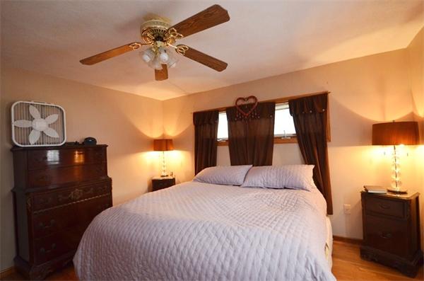 8 Riverside Road Billerica, MA 01821 - Photo 16 of 30 a bedroom with a bed and a chandelier