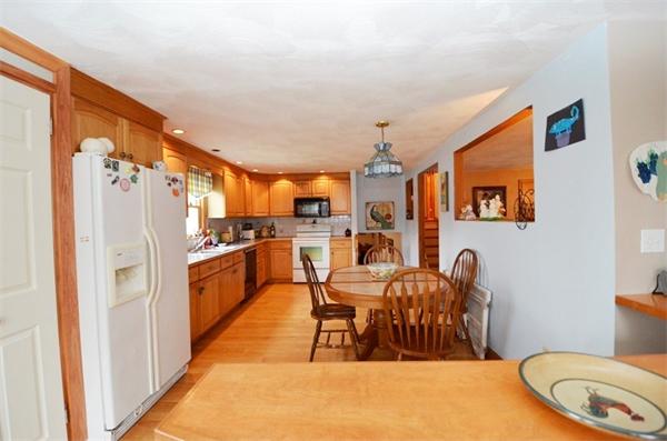 8 Riverside Road Billerica, MA 01821 - Photo 3 of 30 a living room with stainless steel appliances furniture a rug and a kitchen view