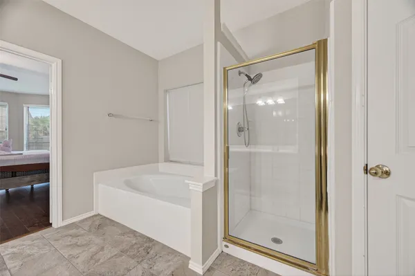 a bathroom with a bathtub and a shower