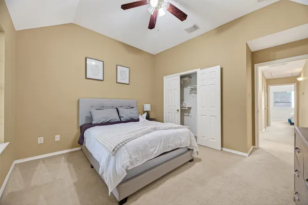 a bedroom with a large bed and a chandelier