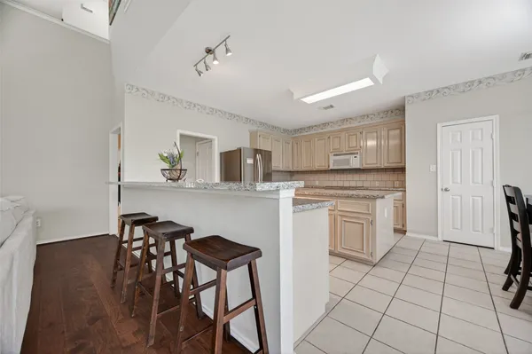 a kitchen with white cabinets and appliances
