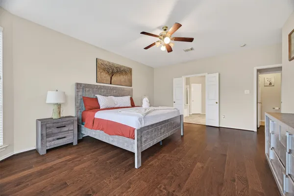 a bedroom with a bed and a chandelier