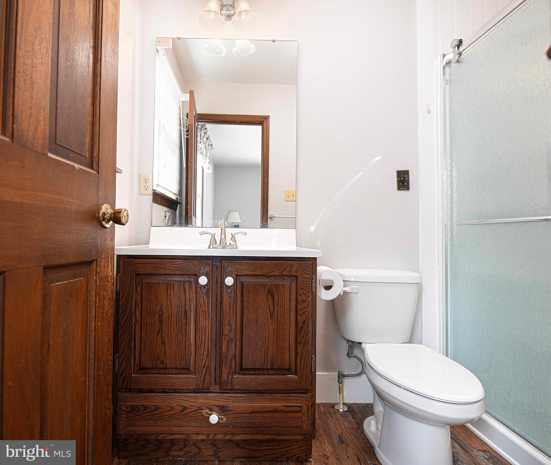 754 Main Street Fawn Grove, PA 17321 - Photo 17 of 40 a bathroom with a toilet a sink and mirror