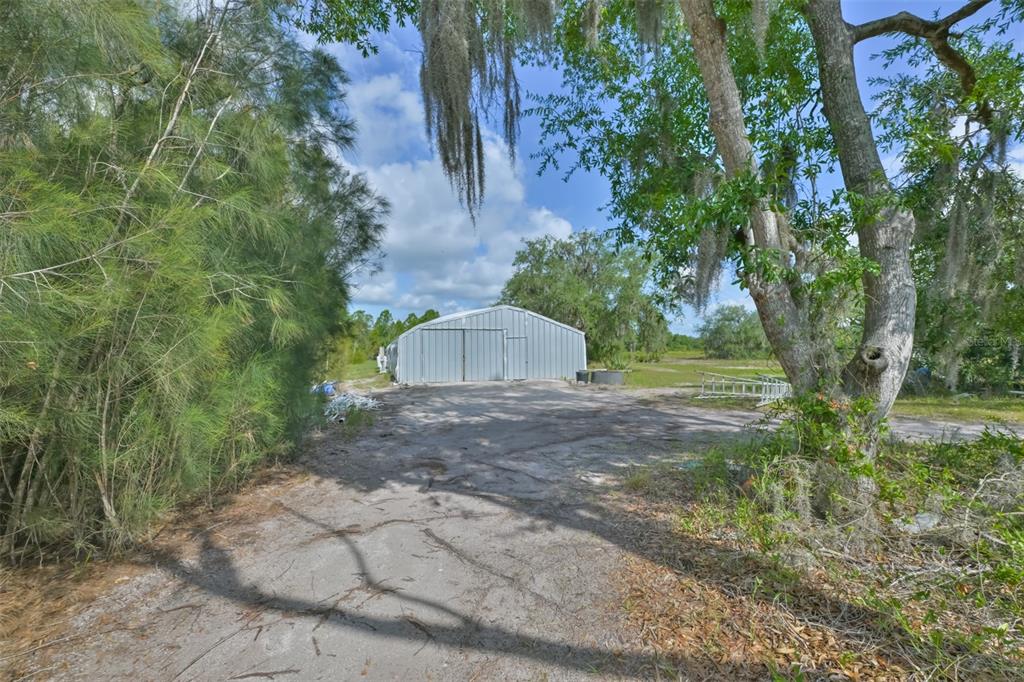 14451 Highland Road Wimauma, FL 33598 - Photo 18 of 80 a view of a tree in front of a house