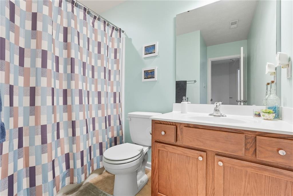 11 Truman Circle McKees Rocks, PA 15136 - Photo 28 of 33 a bathroom with a sink a toilet and shower curtain