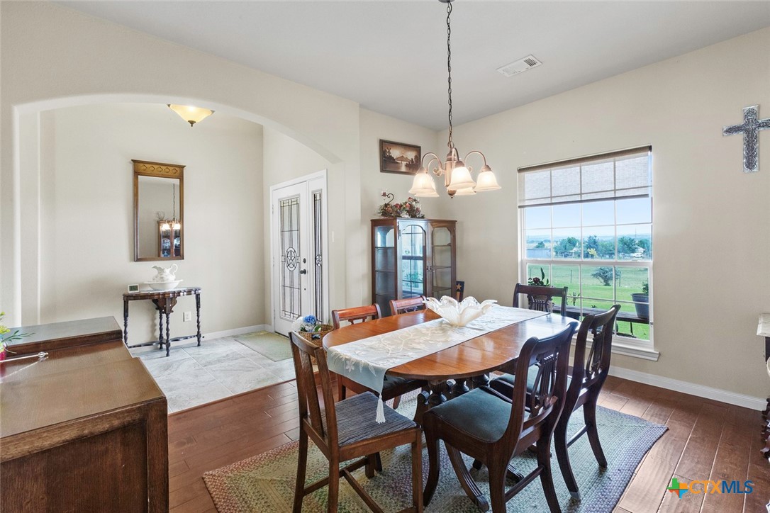 187 Tracks Trail Center Point, TX 78010 - Photo 14 of 41 a view of a dining room with furniture window and wooden floor