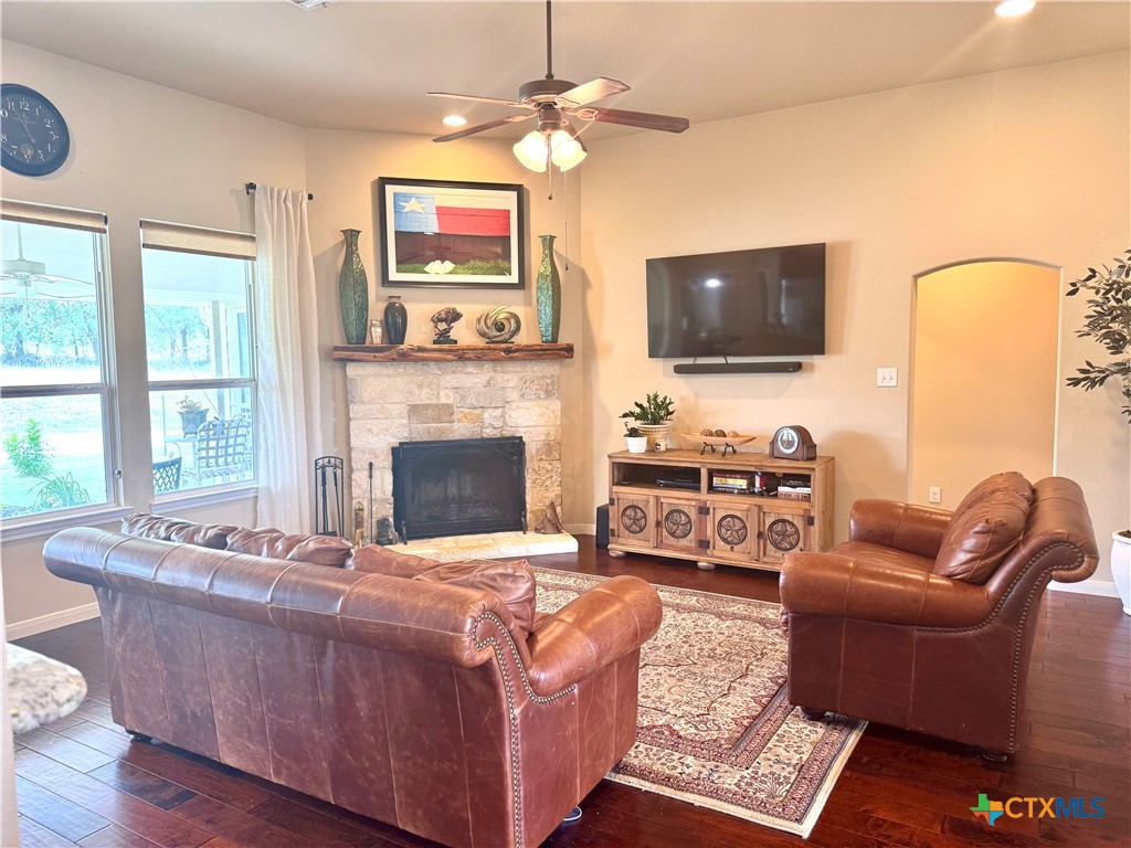 187 Tracks Trail Center Point, TX 78010 - Photo 15 of 41 a living room with furniture a flat screen tv and a fireplace