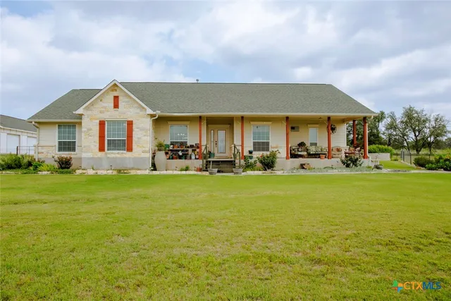 a front view of house with yard and outdoor seating