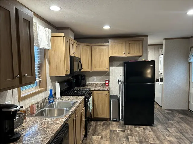 a kitchen with a refrigerator sink and stove