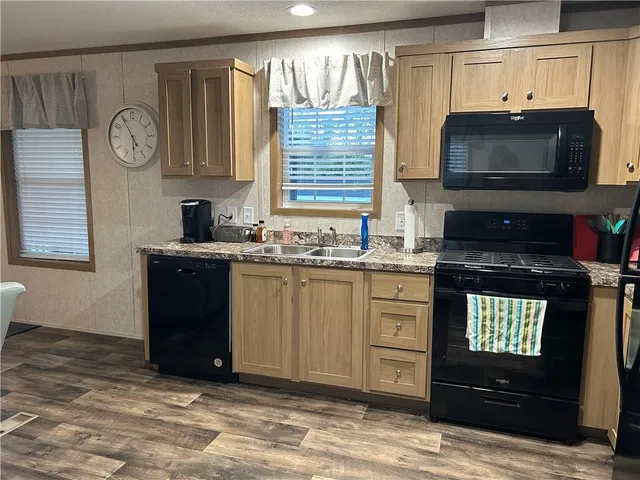 a kitchen with a sink stove and microwave