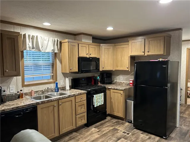 a kitchen with a refrigerator stove and sink