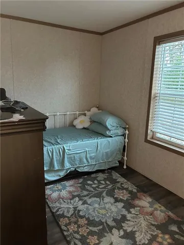 a room with a table chairs and wooden floor