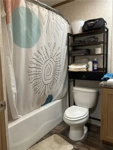 a bathroom with a toilet a sink and mirror