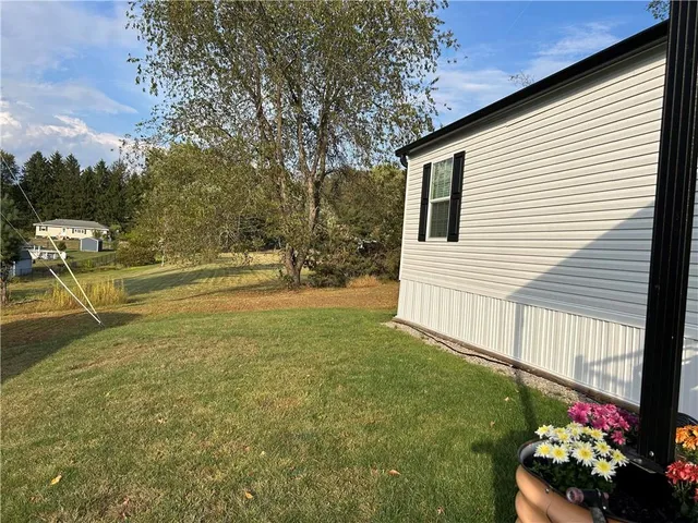 a view of a house with a backyard