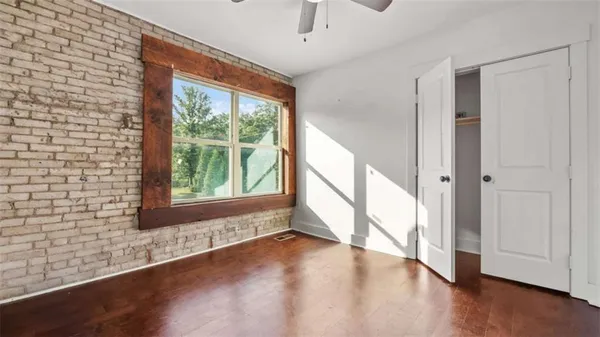 a view of an entryway with wooden floor and windows